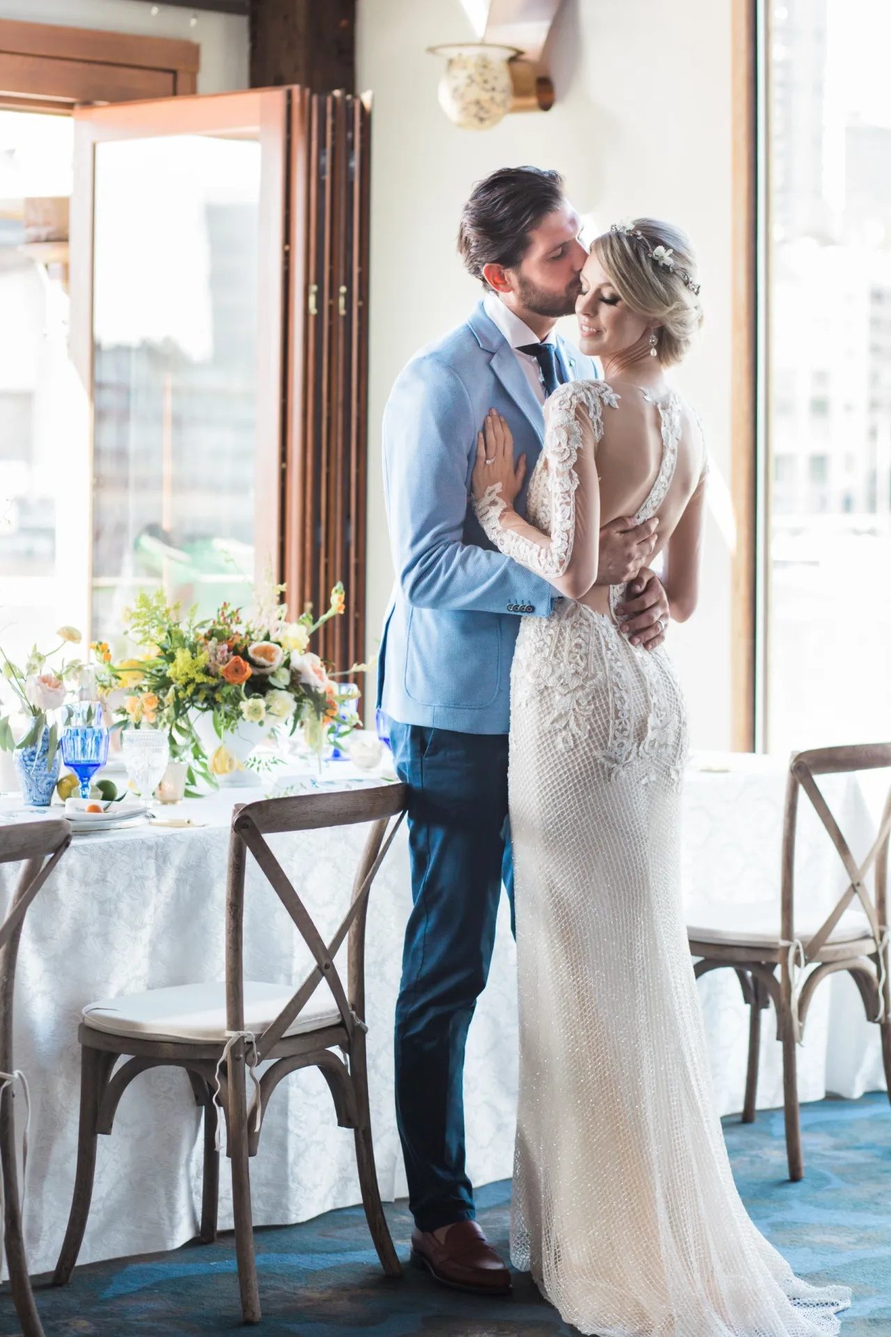 The couple in an embrace, styled in cobalt blue and lace.
